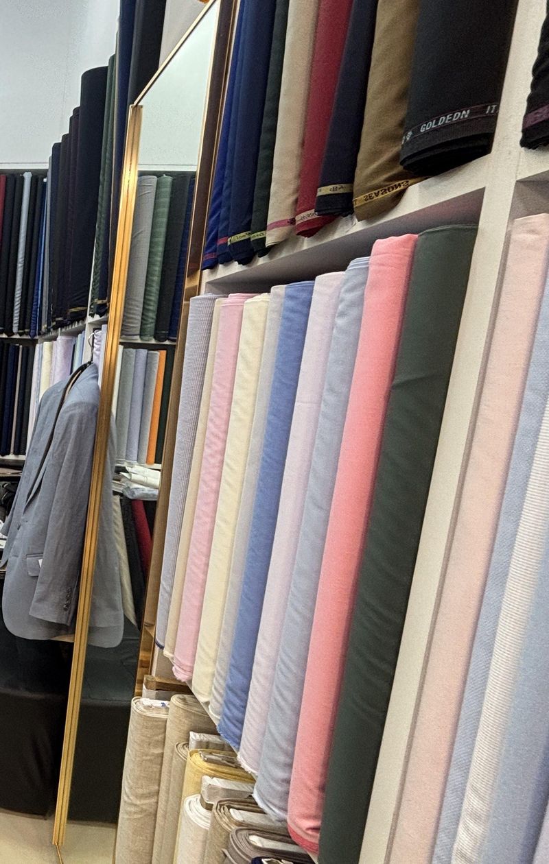 Floor-to-ceiling shelves of cloth in the shop