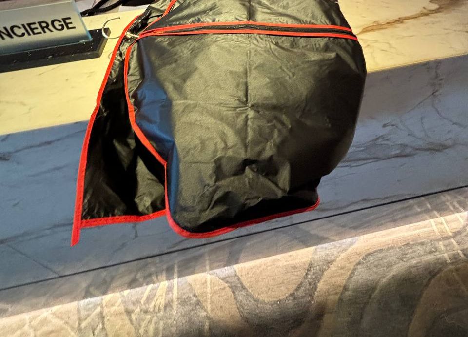 A garment bag laid on a concierge desk