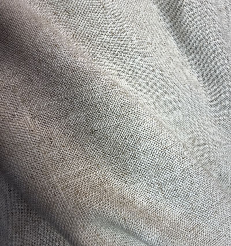 Close view of the weave of a pale grey linen
