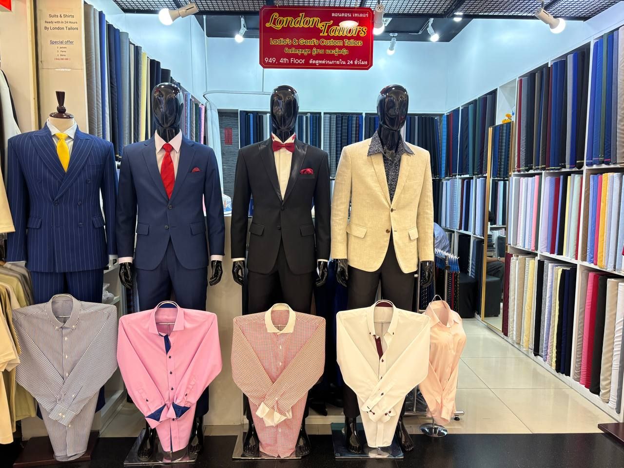 The London Tailors shop front on the fourth floor of Platinum Fashion Mall, Bangkok: four suited mannequins, made-to-measure shirts on display and floor-to-ceiling shelves of cloth