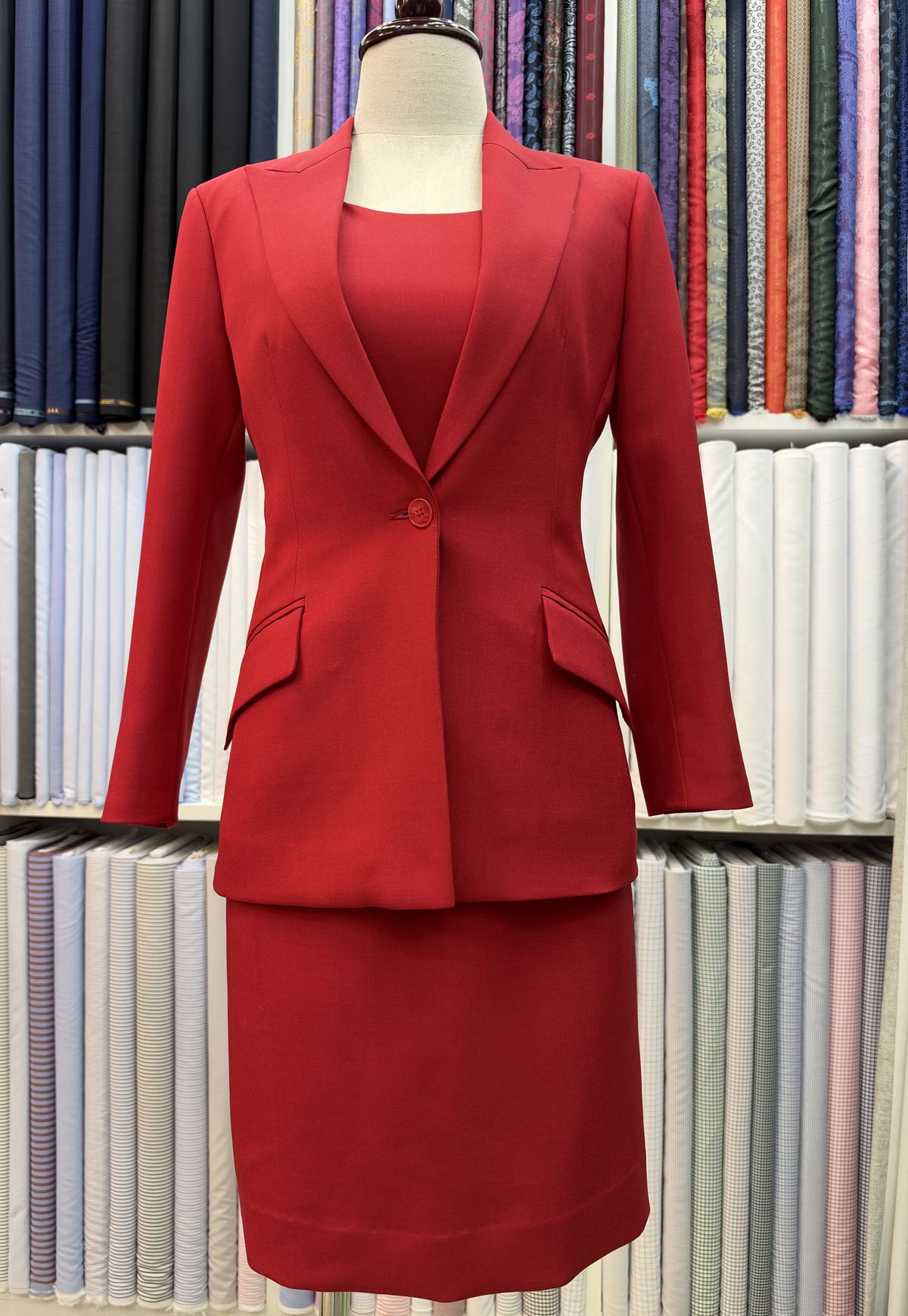 Red women’s skirt suit on a dress form